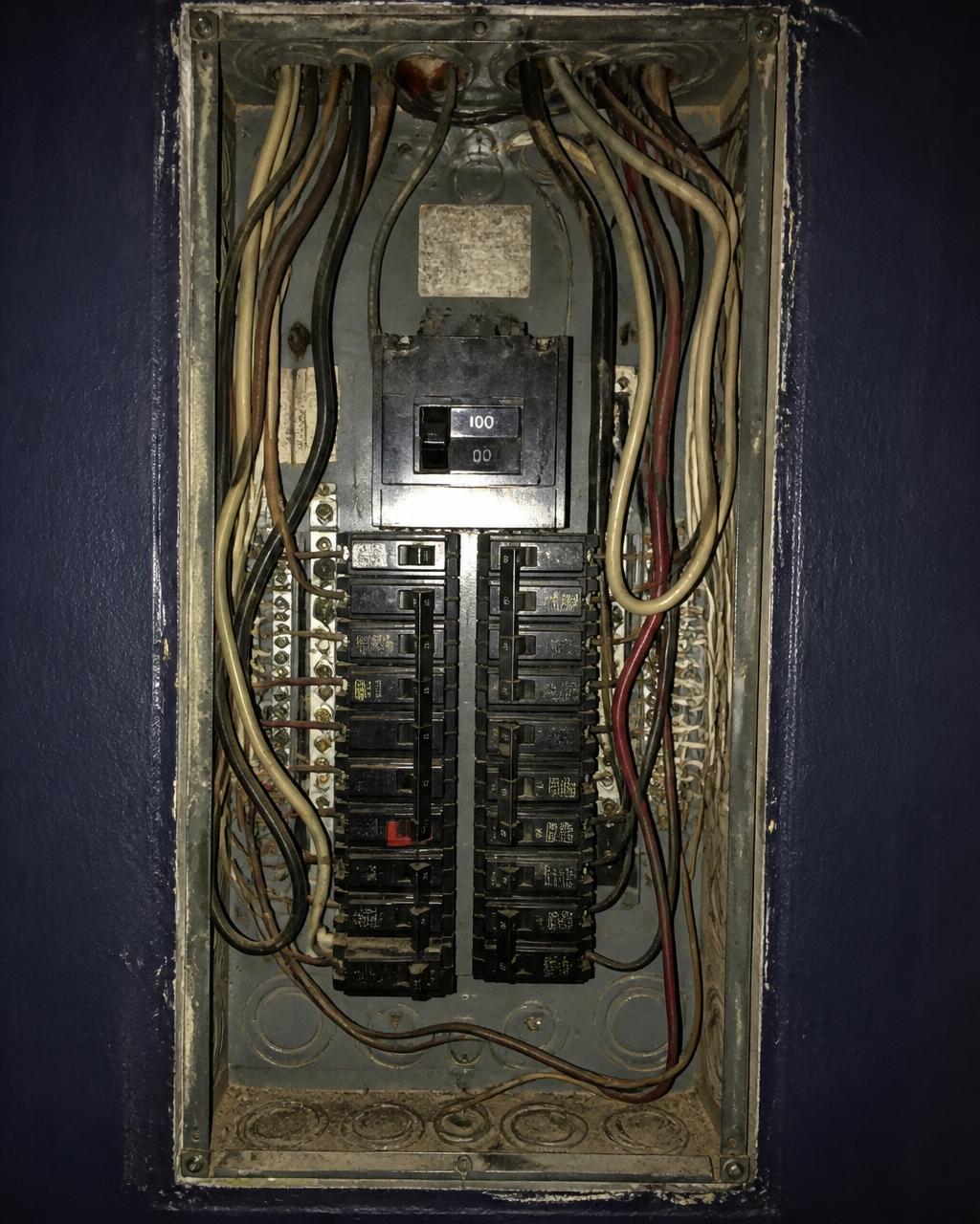 Outdated 100A residential panel with disorganized wiring